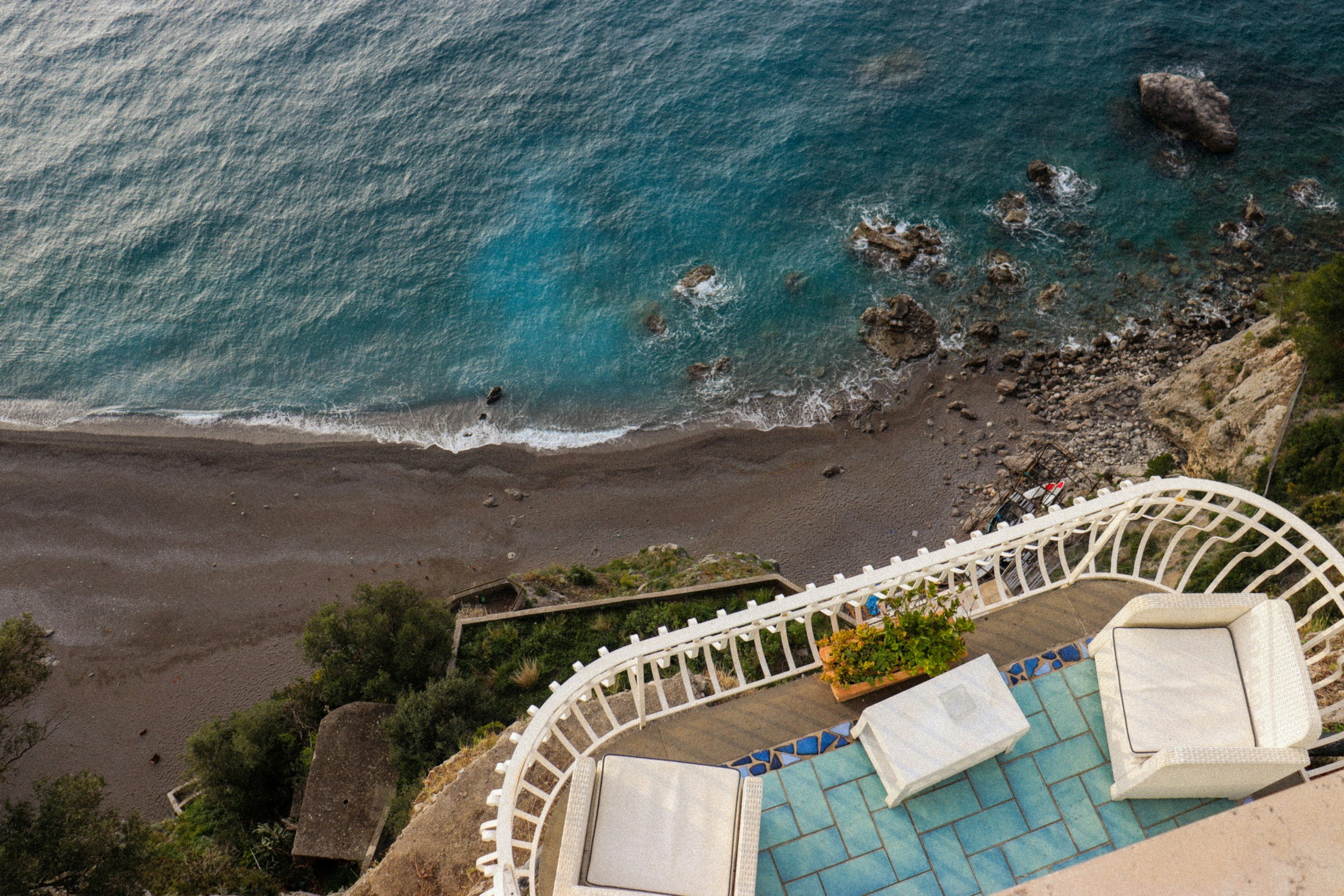 A coastal road winding along the cliffs above the sea on the Amalfi Coast