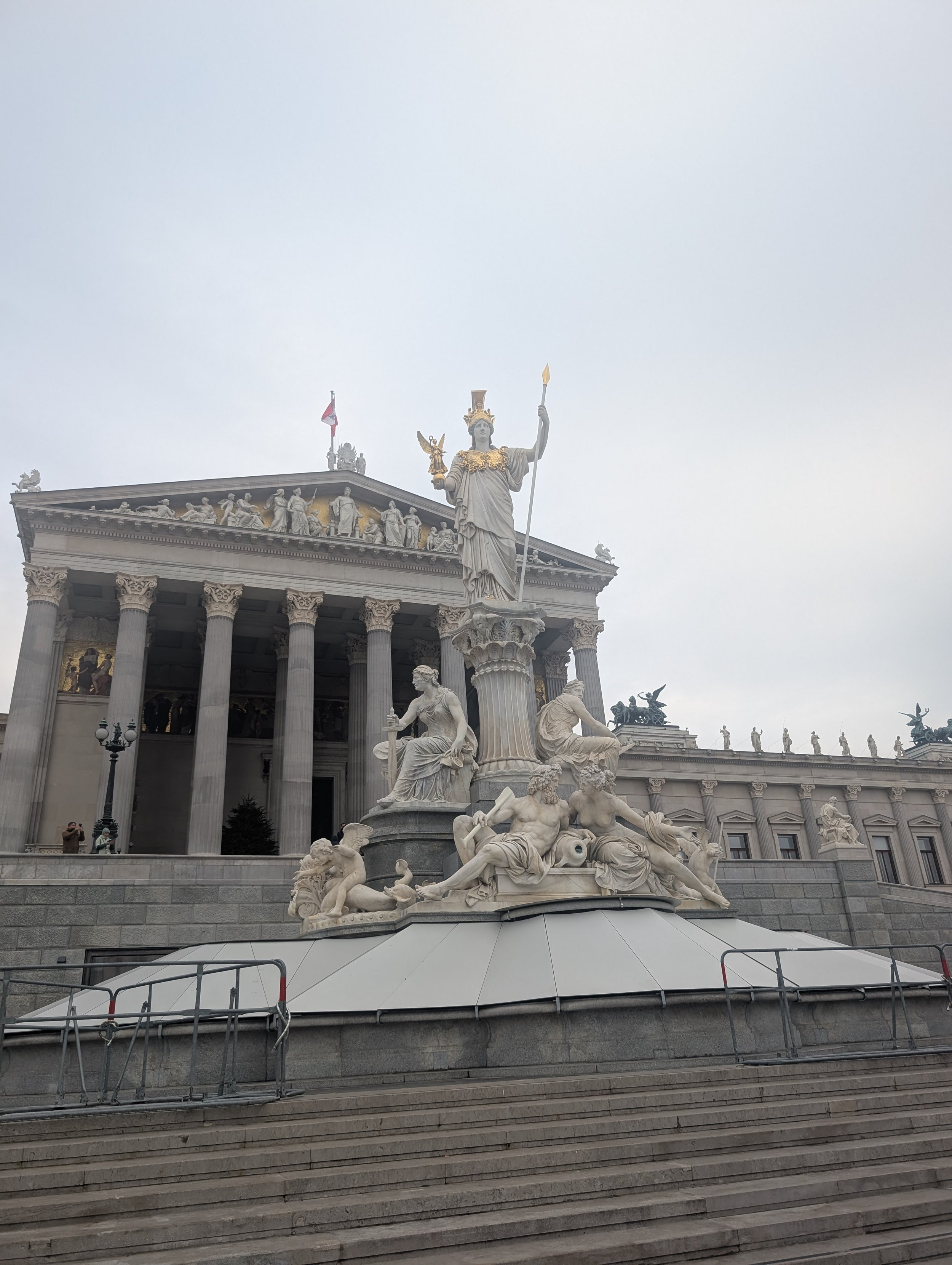 A grand historic building along a street in central Vienna on a winter day