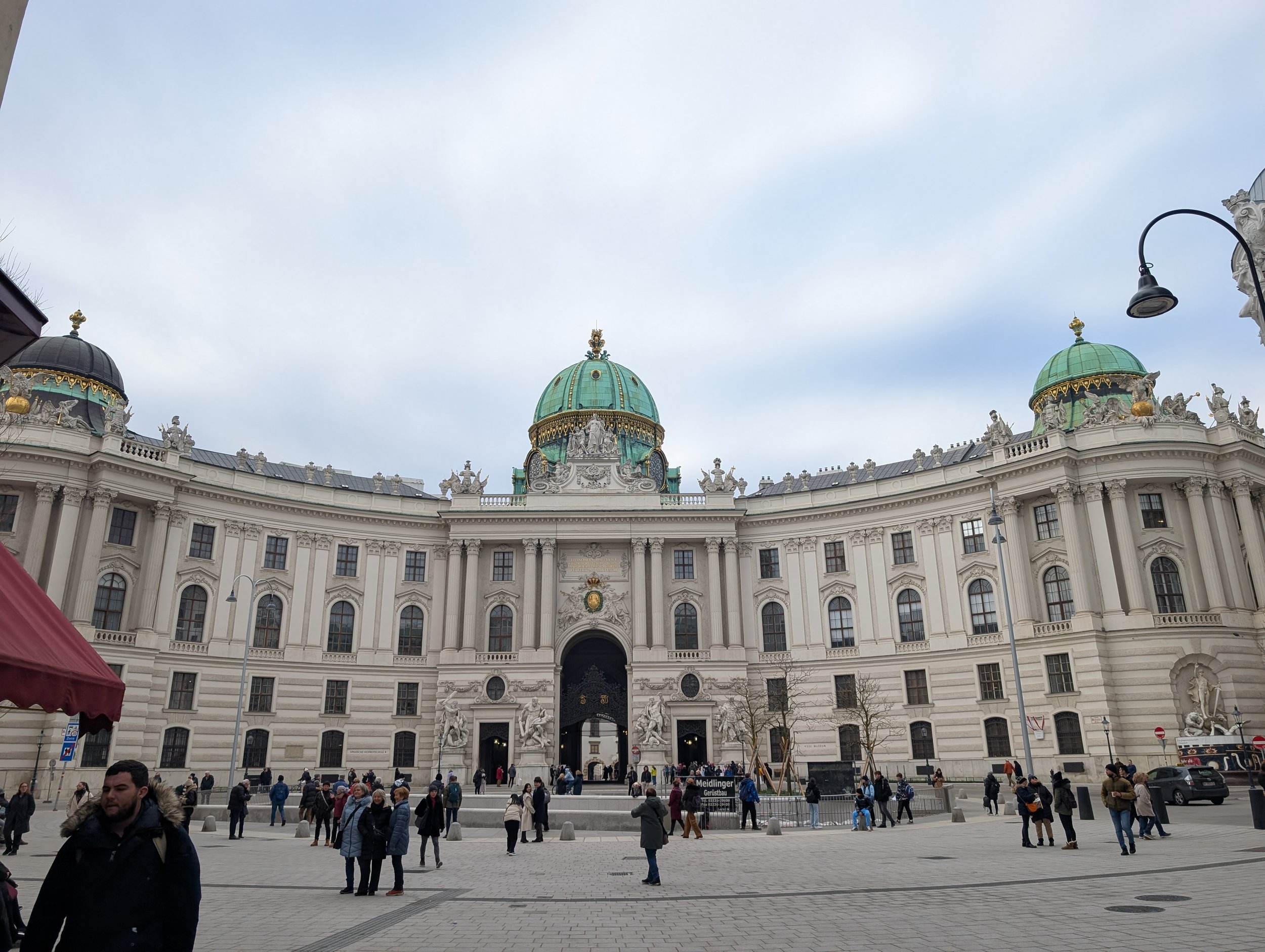The Hofburg's Michaelertrakt with its green domes above Michaelerplatz on an overcast morning