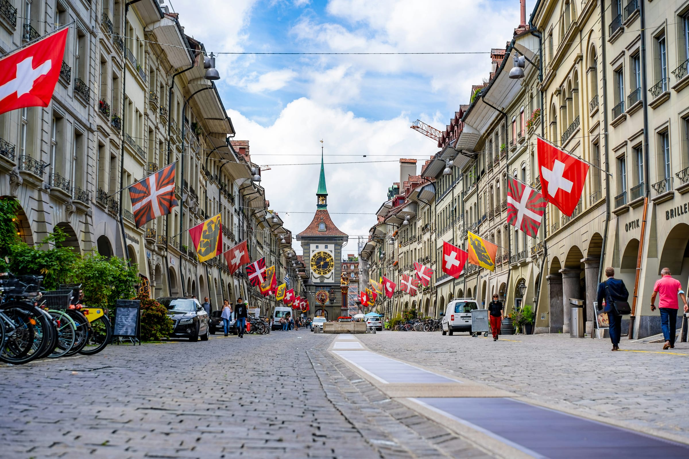 Medieval sandstone arcades and red rooftops along the Aare River in Bern, Switzerland