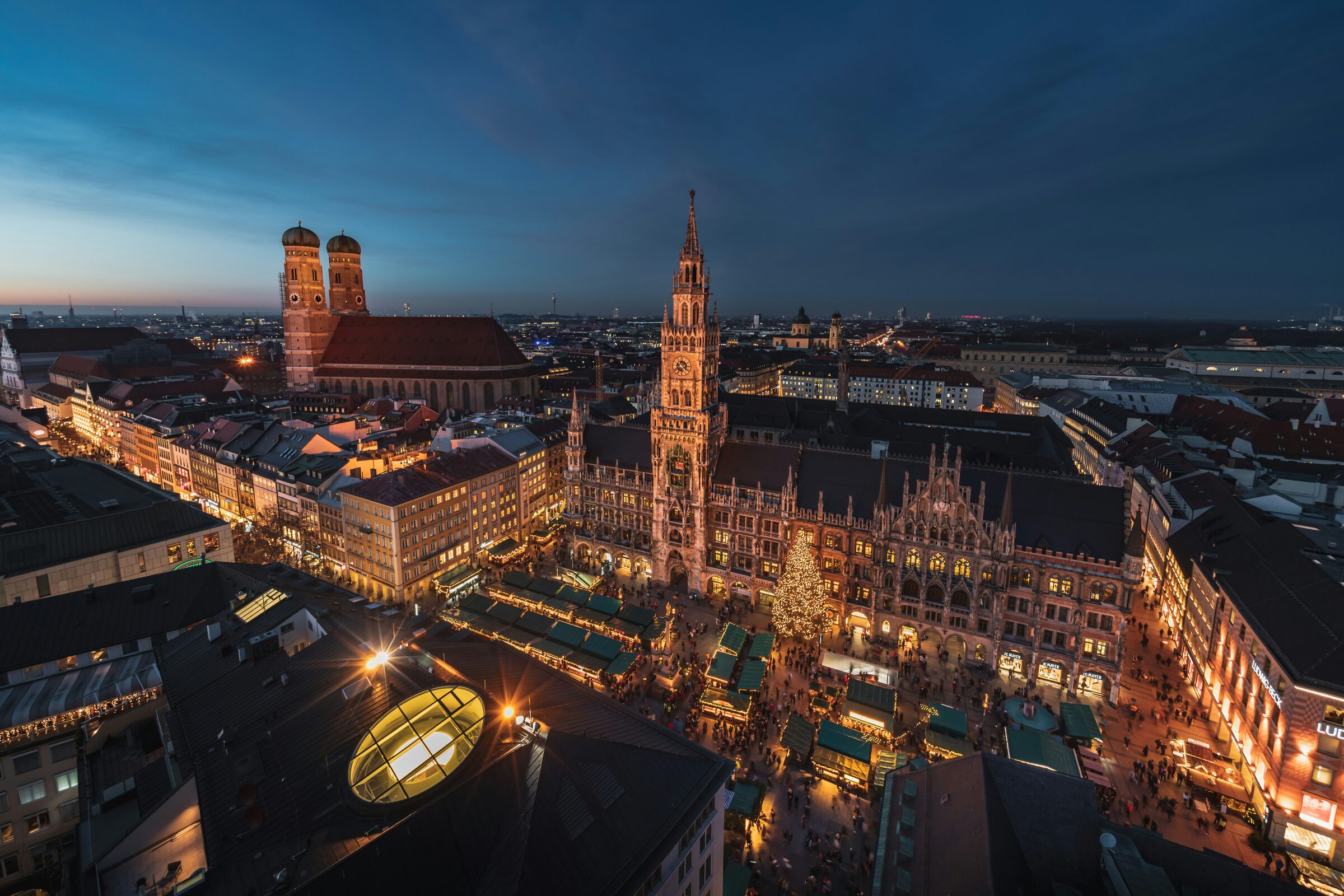 A historic square with ornate facades and church towers in Munich, Germany