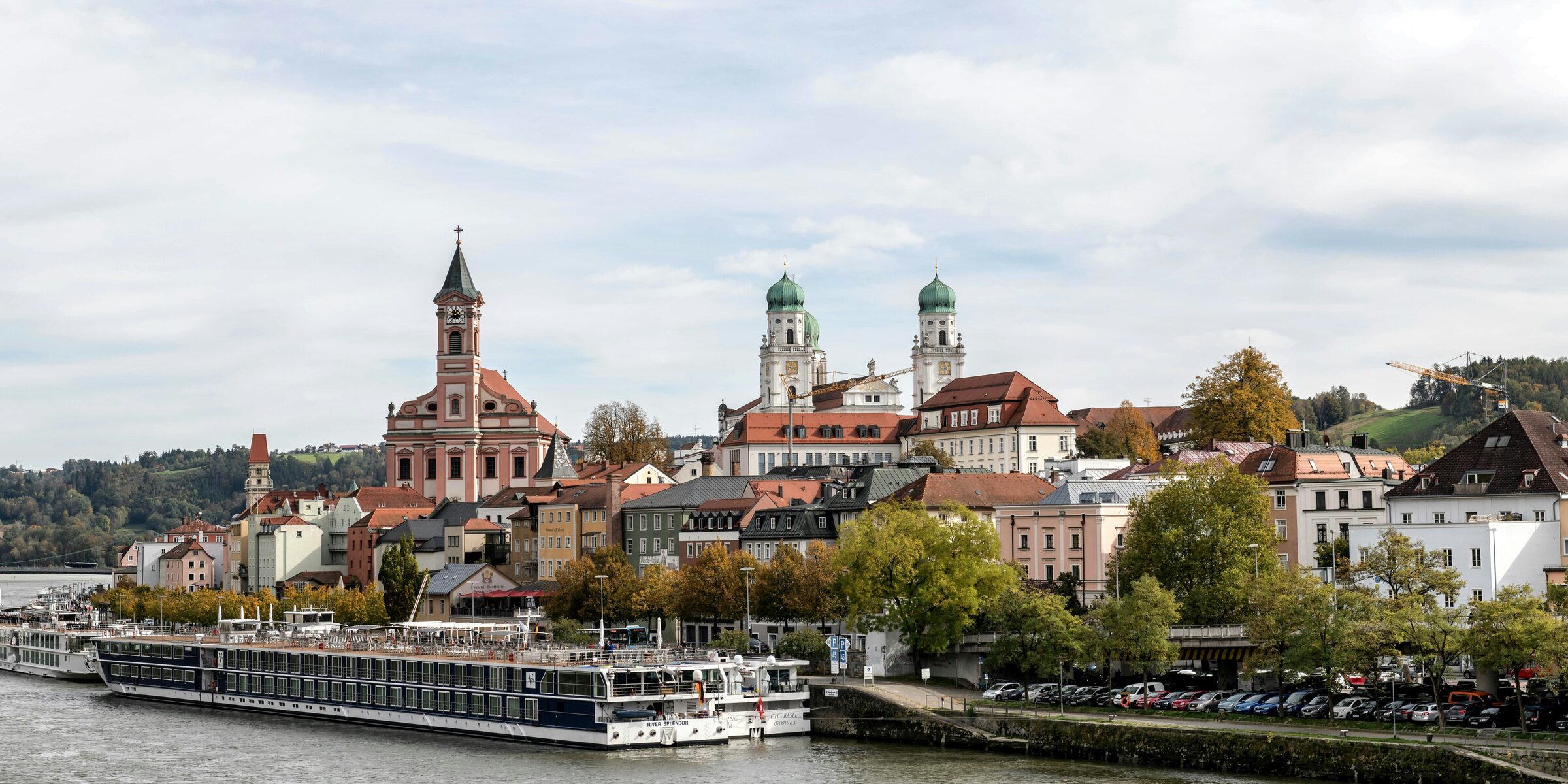 Pastel baroque buildings at the confluence of three rivers in Passau, Germany