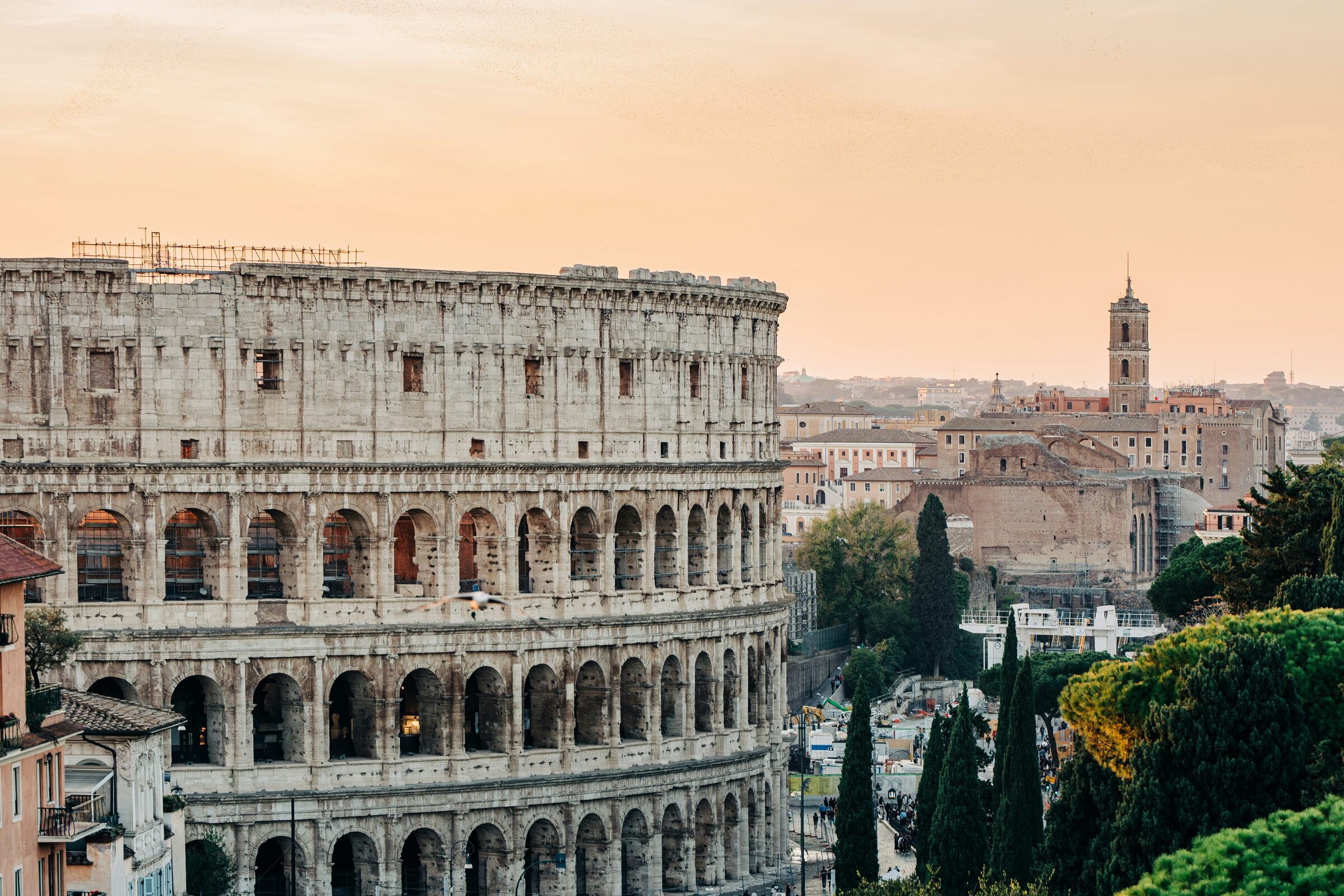 The ancient Colosseum standing among the ruins of Rome