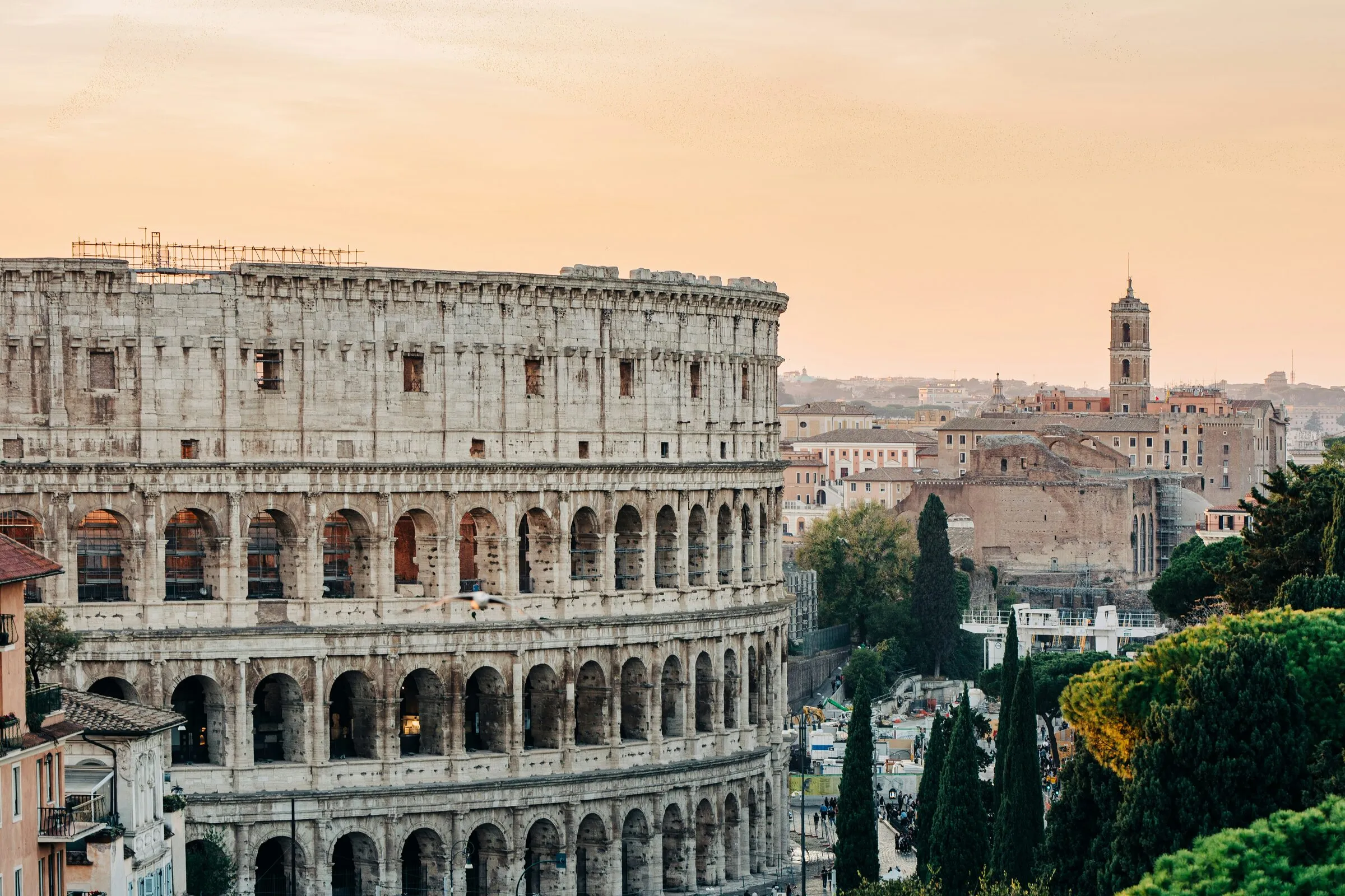The ancient Colosseum standing among the ruins of Rome