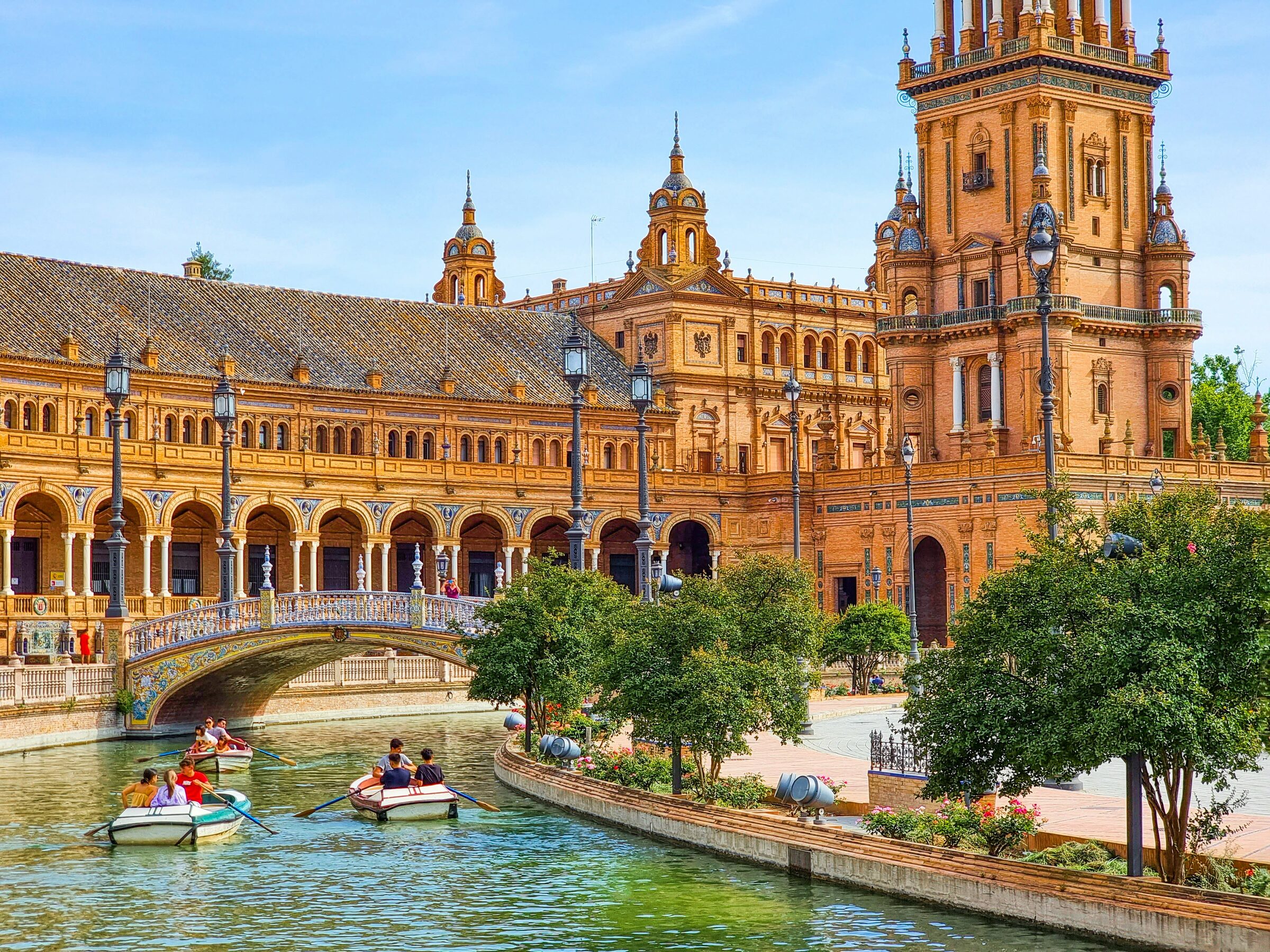 The ornate Plaza de Espana with its curved brick arcades in Seville, Spain