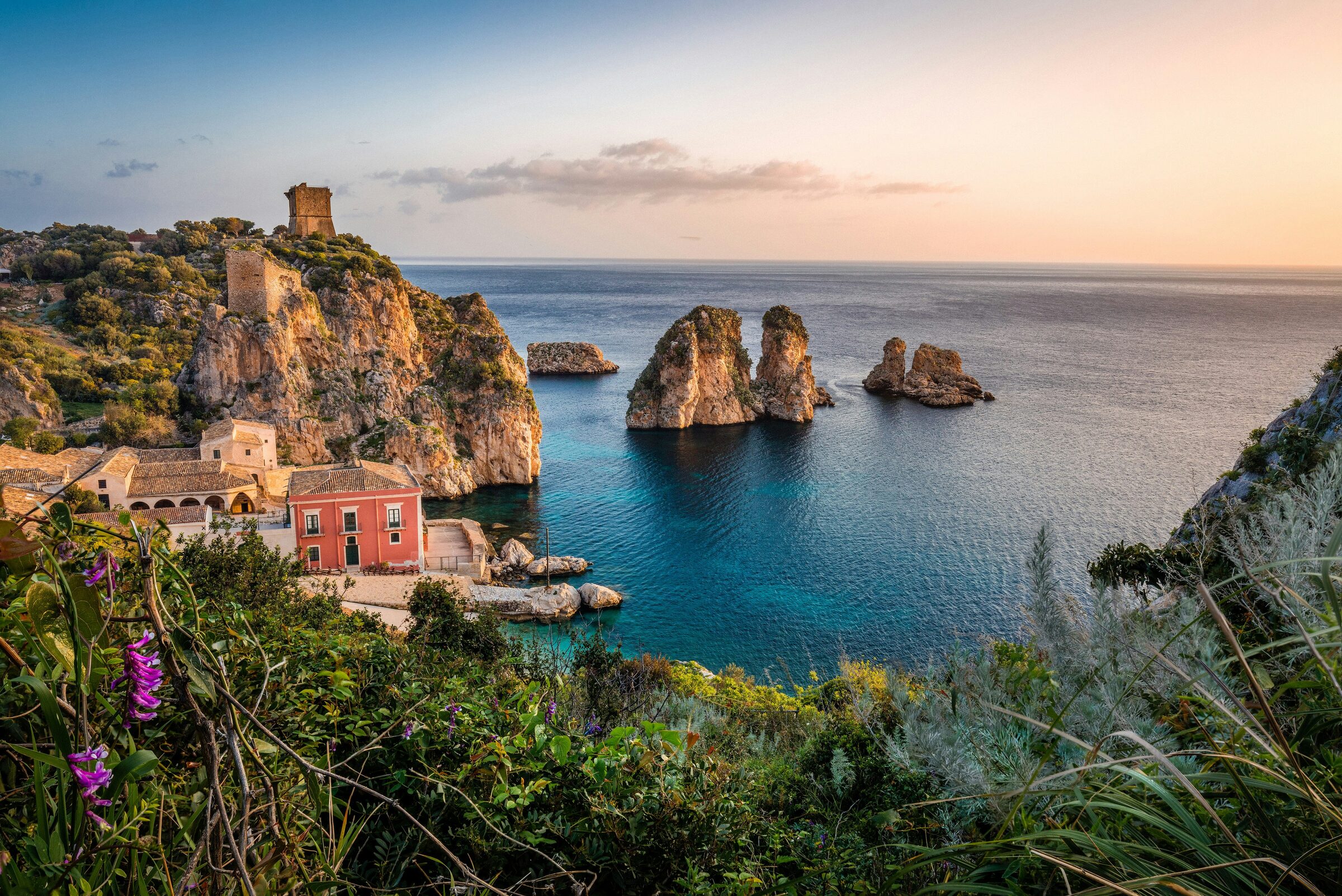 A coastal town with the sea and Mount Etna in the distance in Sicily, Italy