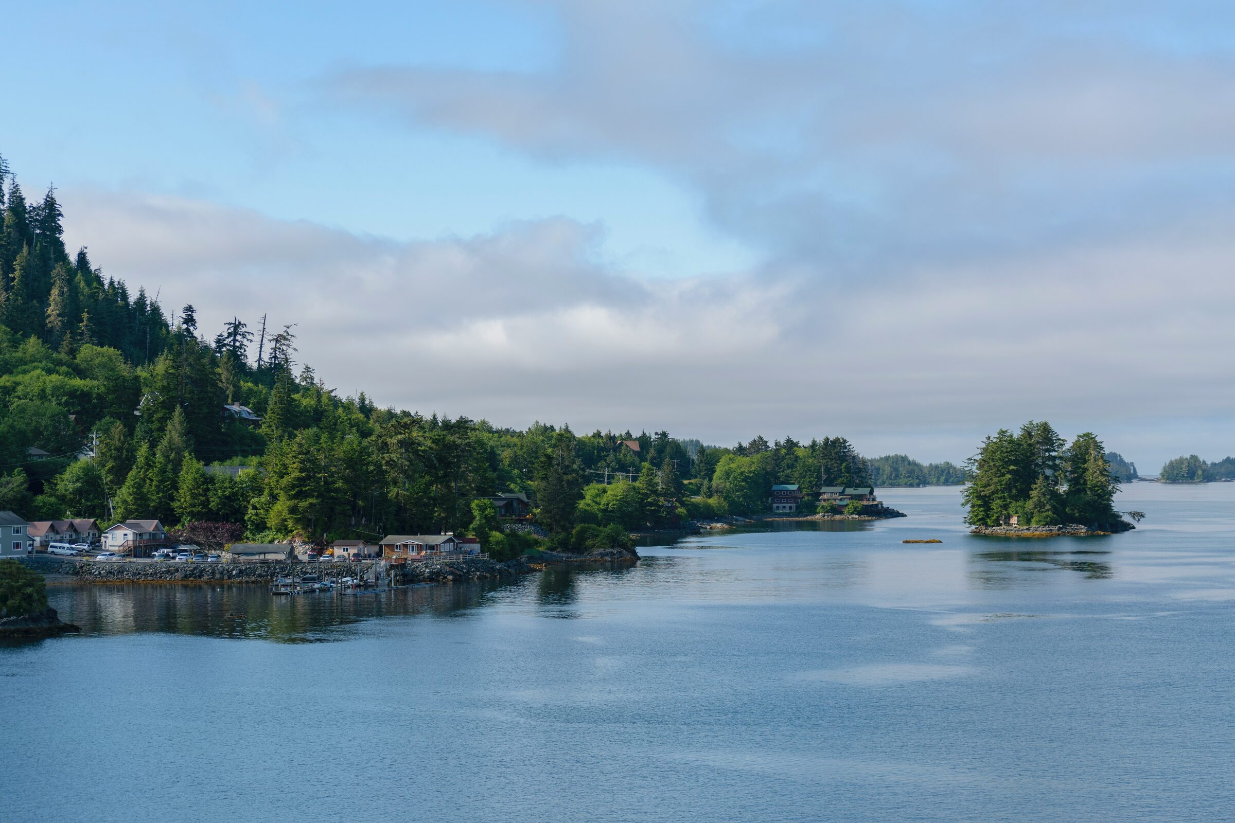 Forested islands and snow-capped mountains along the waterfront of Sitka, Alaska